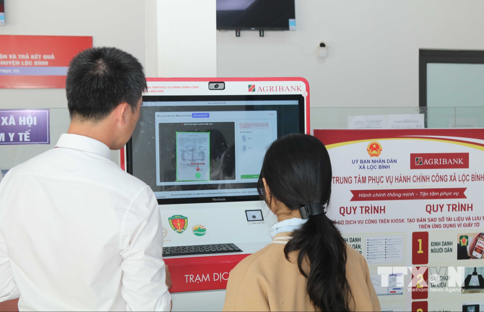 Người dân xã Lộc Bình, tỉnh Lạng Sơn thực hiện thủ tục hành chính qua “Trạm dịch vụ công số”. (Ảnh: Quang Duy/TTXVN)